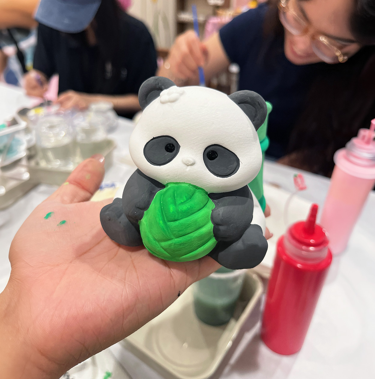 Child painting a ceramic piece