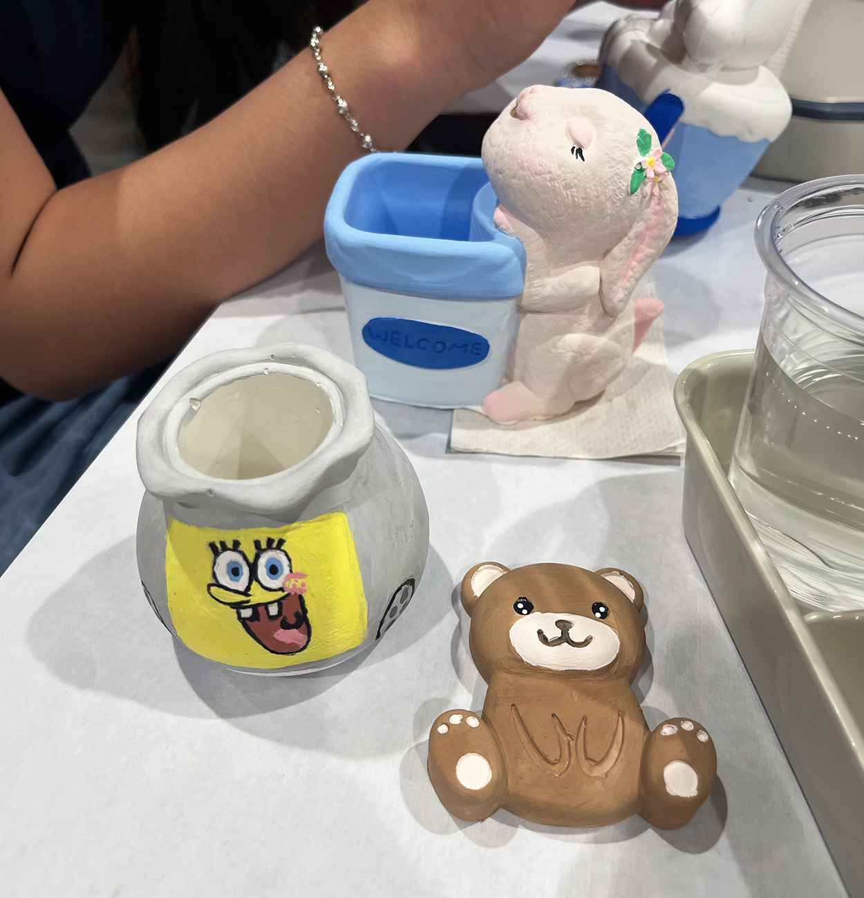 Child painting a ceramic piece