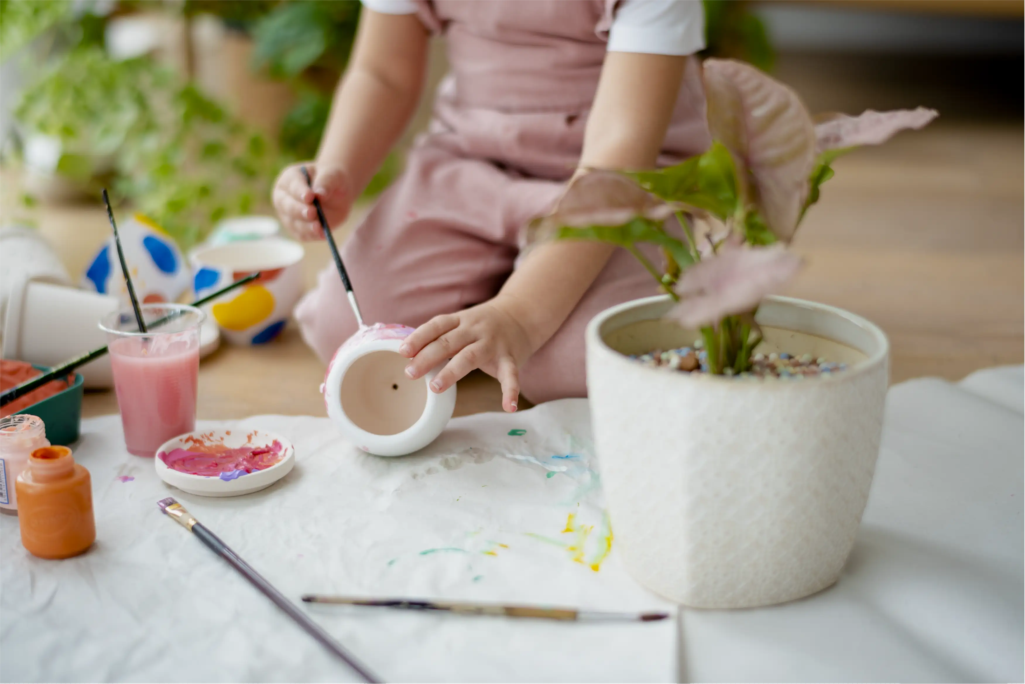 Child painting a ceramic piece